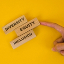 three wooden bricks with the words diversity, equity, and inclusion.