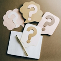 note pad with question marks all around it. 
